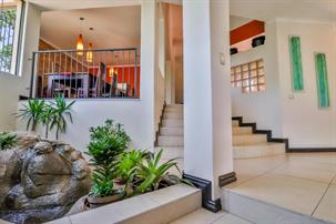a photo of a staircase leading up from the entrance hall